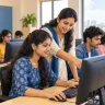 Students practising computer skills in a classroom with a teacher